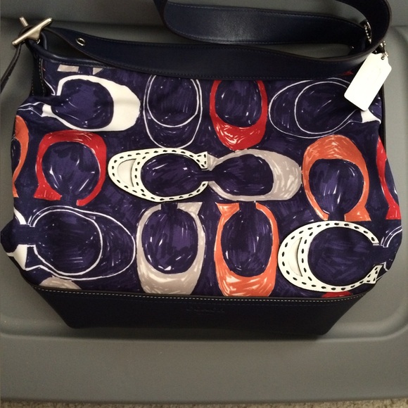Coach Handbags - Coach cloth/leather purse. Has spots on the bottom in the leather. See photos